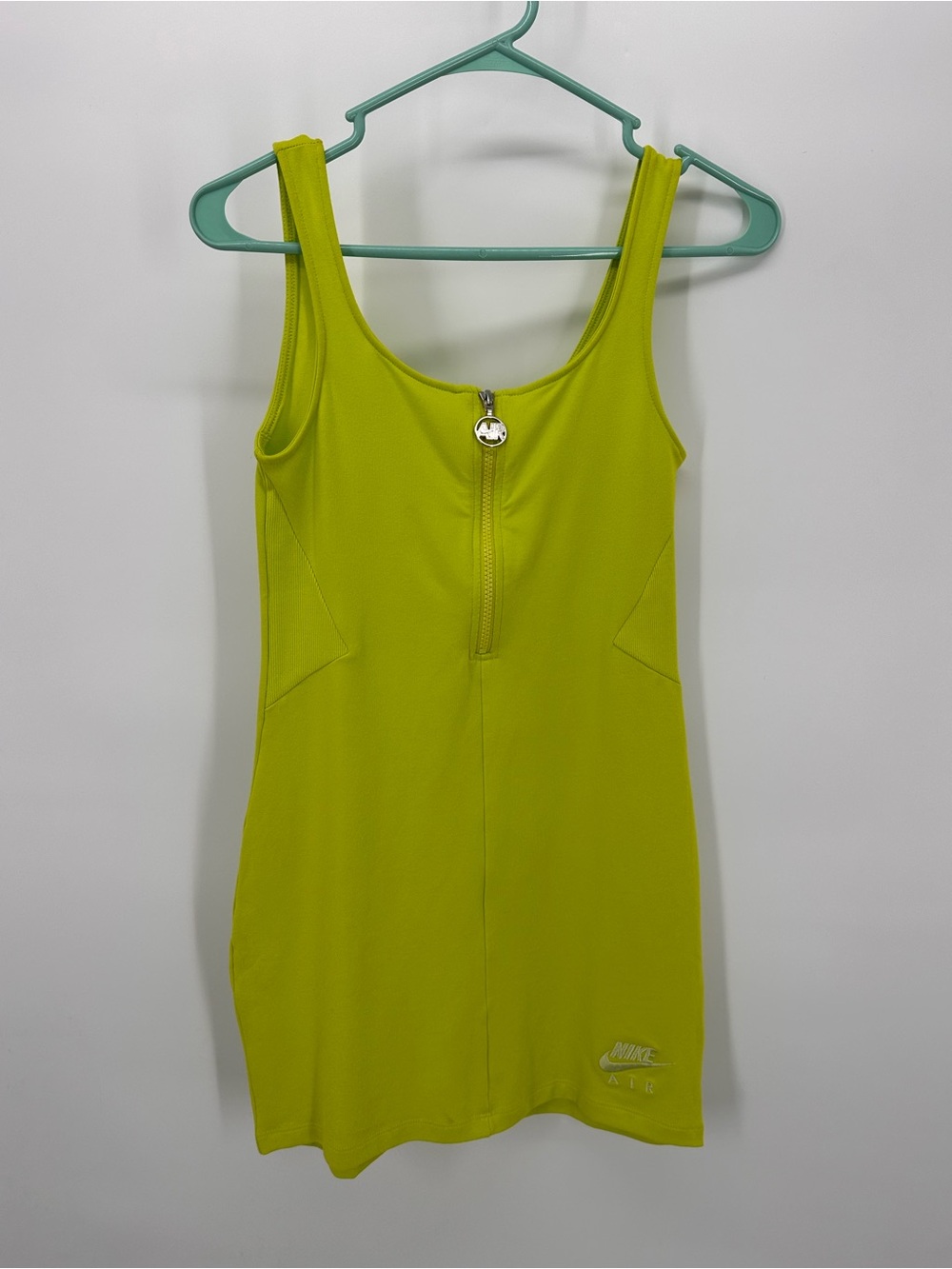 Women’s Nike Air Dress in Atomic Green with front zipper pull.